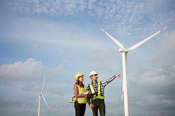 Two engineers discussed the plan for the maintenance of wind turbines. Renewable energy with wind...