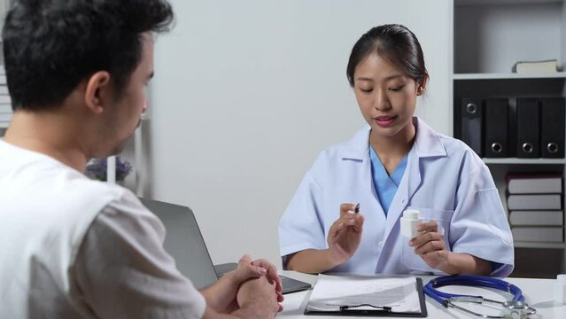 Asian female doctor or medical specialist examining a patient Ask for symptoms, give advice, recommend medication, plan treatment guidelines and preventive care. Concept of health checkup Prevention