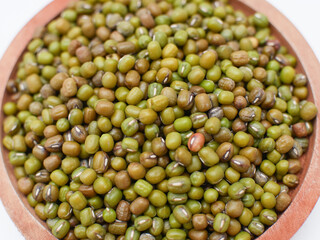 close up of green bean seeds on a wooden plate