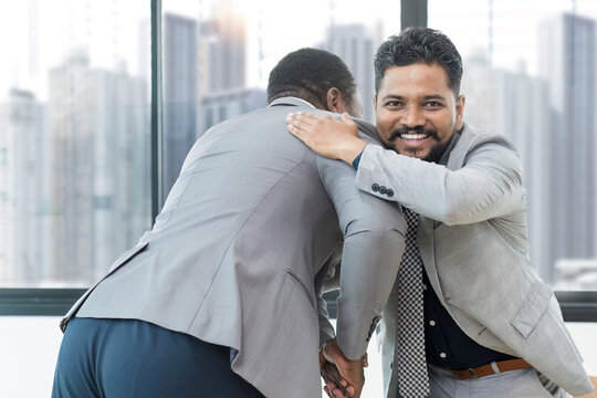 portrait customers indian and Real estate agents African American customers indian shake hands to congratulate on signing a contract to buy a house with land