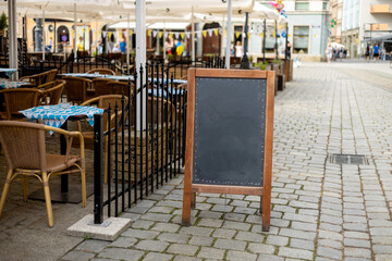 Restaurant sidewalk chalkboard sign board. Old Blak Signboard on the street. Blank store signage sign design mockup isolated