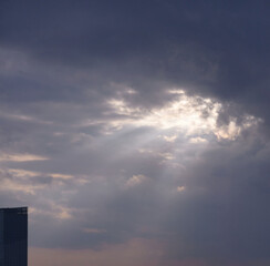 The sun shines through the gaps in the clouds