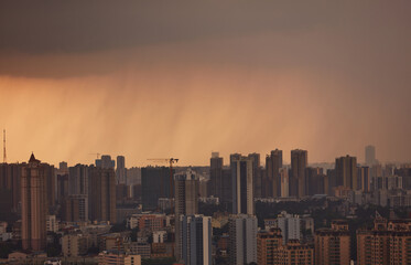 Heavy rain on city skyline at dusk