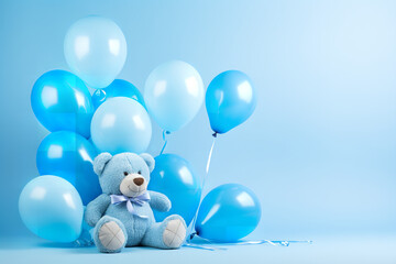 blue balloons and a blue teddy bear on light blue background studio light