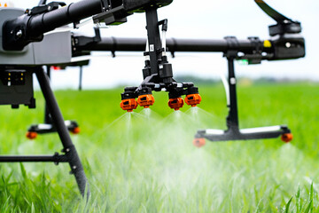 Spraying nozzle of agriculture drone spraying on field 