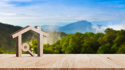 Fototapeta na wymiar Mockup wooden house and key on wooden table, concept of real estate investment. Planning savings money of coins buy home concept for property, mortgage and real estate investment.