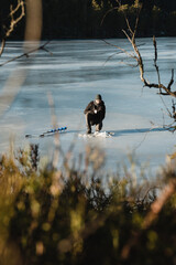 a man on a frozen lake fishing