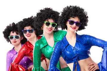 A group of girls in disco style and African wigs in colorful costumes on a white background. Singers and dancers of the eighties and seventies.