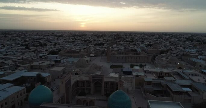 A drone flies over the old city and the famous memorial complex iKalyan Poi Kalon Complex and Poi Kalon Minaret n Bukhara at dawn