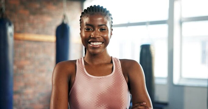 Fitness, face and a black woman with arms crossed at the gym for health, sports or workout. Happy, portrait and an African person or athlete with confidence in exercise, training or cardio at a club
