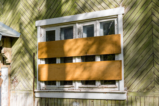 Boarded up outside windows of an old house after resettlement