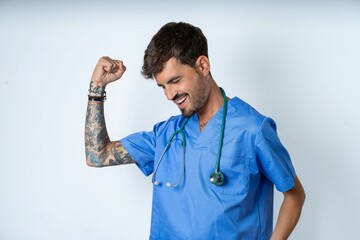 Profile photo of excited young caucasian doctor man wearing blue medical uniform good mood raise...