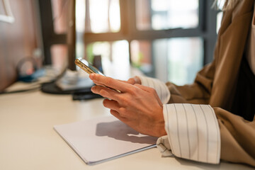 Shot of elegant young business woman smiling and  using mobile phone while walking, Copy space.