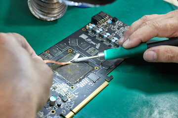 Cleaning the contact group of the video card for soldering the GPU chip. Soldering iron C245. Maintenance and repair of computer equipment.