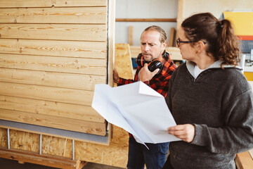 Carpenters Reviewing a House Plan