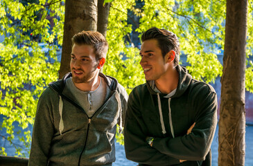 Photo of two men posing in front of a picturesque forest backdrop