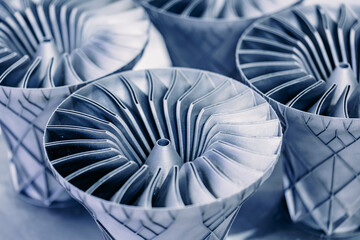 Closeup steel blades of turbine propeller 3D printing. Concept modern industrial additive...