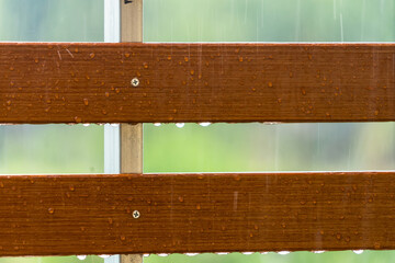 Drops of water on wooden bench after the rain, natural weather background - 641213116