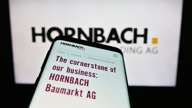 Stuttgart, Germany - 08-22-2023: Smartphone with webpage of German company Hornbach Holding AG Co. KGaA on screen in front of business logo. Focus on top-left of phone display.