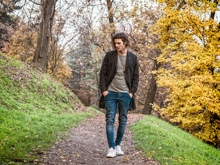 Fototapeta premium Photo of a man walking through a serene forest path