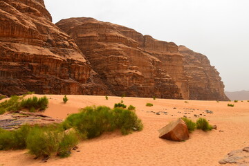 Wadi Rum Desert, Jordan. The red desert and Jabal Al Qattar mountain. 8th July 2023. On a hot spring cloudy day. 