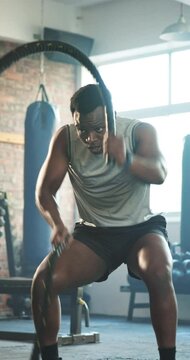 Gym, rope and black man with exercise, training and fitness with endurance, muscle and wellness. African person, athlete and guy with workout, training and bodybuilder with health, energy and power