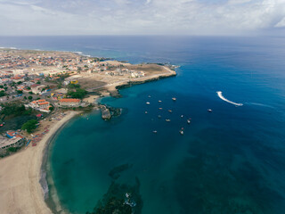 Fototapeta na wymiar Aerial drone Tarrafal in Santiago Island, Cabo Verde showcase golden beaches, azure waters, and rugged mountains, it's a paradise for nature lovers. The charming town, historic sites