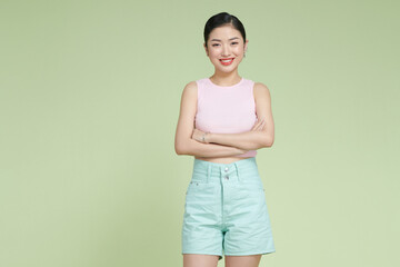 Confident nice smiling asian woman cross arms chest confident on light green background