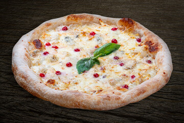 Pizza Four Cheese with smoked suluguni, gorgonzola, mozzarella, mountain ash, walnuts, honey, basil. Neapolitan round pizza on wood background
