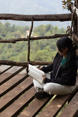 In the middle of the exuberant vegetation, a happy woman in the pages of a book harmonizing with...
