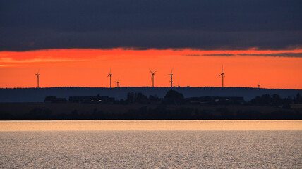 Wind turbine, renewable energy, at sunset. Clean electricity for climate change