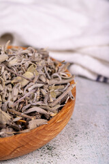 Fototapeta na wymiar Dry Sage leaves. Dried salvia or sage leaves in wood bowl. herbal medicine