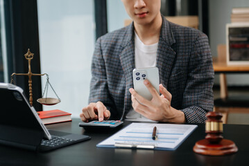 Women counting coins on calculator taking from the piggy bank. hand holding pen working on calculator to calculate on desk about cost at home office..