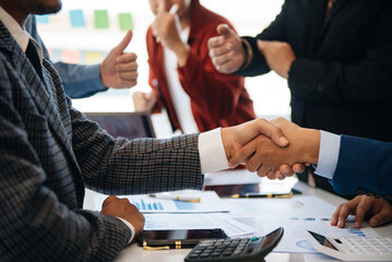 business people shaking hands during a meeting in modern office