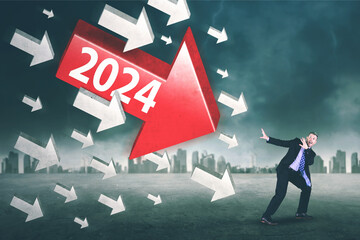 Scared businessman attacked by arrows with 2024 numbers