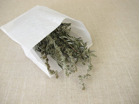 Dried mugwort and a white paper bag