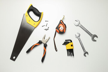 Construction tools on white background, top view