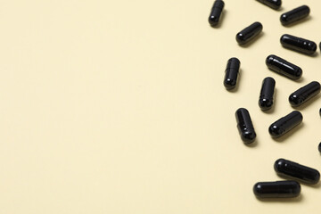 Tablets of activated carbon on a light background