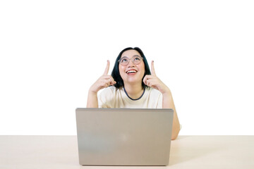 Asian female working on laptop with finger point up at empty space