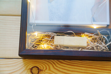 packing wedding photos in a beautiful wooden box.