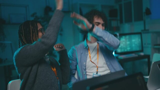 Group of programmers creating innovative software, giving each other high five