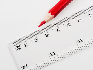 school background with transparent ruler and red pencil