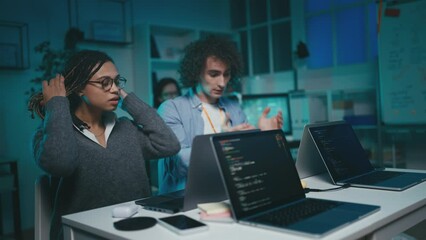 Young IT developers working on a difficult project, harsh deadlines, exhaustion