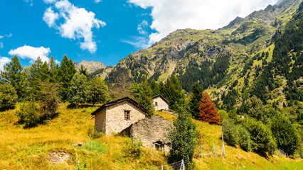 Alpine mountains in summer. An old outbuilding made of stone on a mountainside
