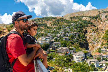 Naklejka premium A father with his son in the Ottoman Castle Fortress of Gjirokaster or Gjirokastra. Albanian