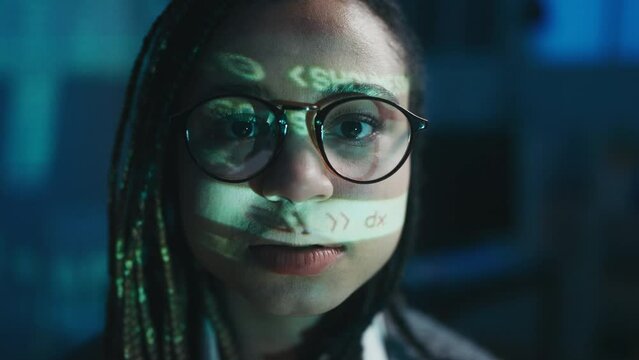 Portrait of African American woman with computer code projecting on her face