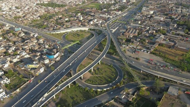 4k: Drone flying over a traffic flyover with ongoing city traffic in Punjab, Pakistan
