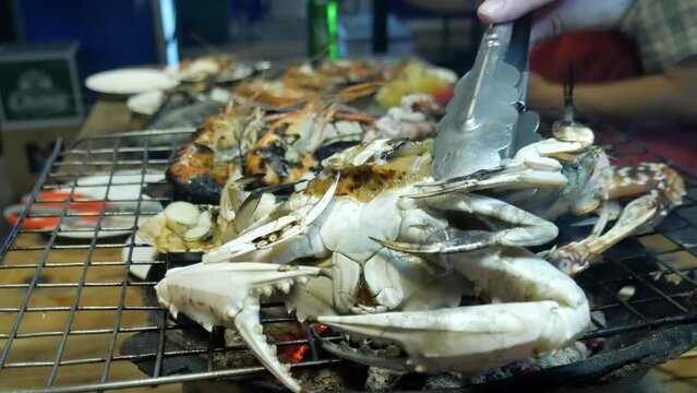 grill cooking blue crab on hot charcoal at thailand bangkok seafood restaurant