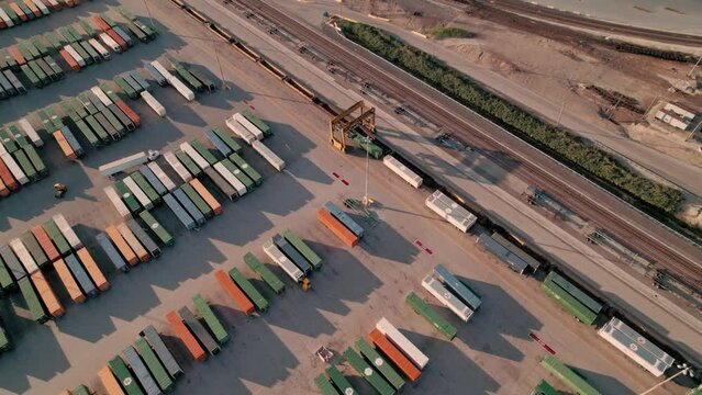 impressive aerial  of container handler driving above lined up containers.  Intermodal Terminal Rail road - yard full of trailers Parked. Northlake, Illinois, Union Pacific Railroad - Global II