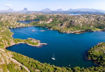 Aerial view of mountains peaks and lakes near Achmelvich Bay, Scotland